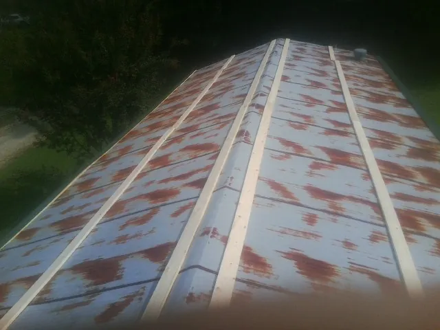 Rusted metal roof panels with new wood purlins before replacement — Storm Damage Roof Repair in Whitehouse by Roofing Brothers