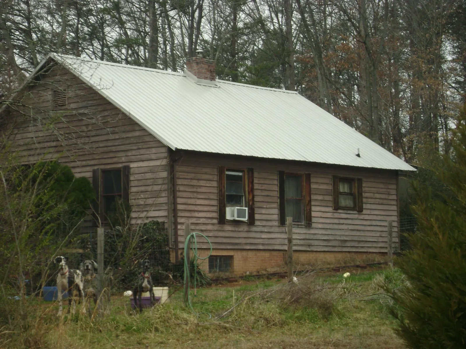 White metal roof on an old wood sided farmhouse, from a Metal Roof Installation job in Whitehouse